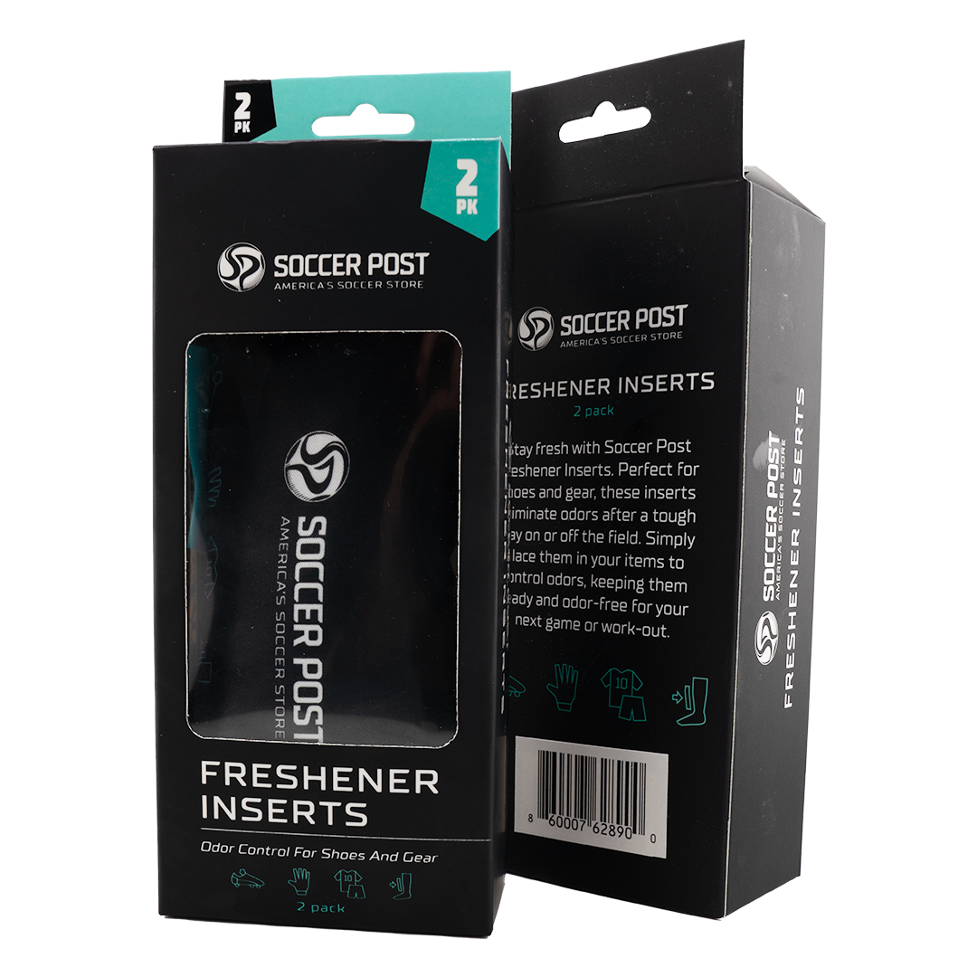 Two black boxes of Soccer Post Freshener Inserts are shown side-by-side against a white background. One box is positioned to show the front with a clear window revealing a black insert inside, while the other shows the side and back with product descriptions and a barcode. Both boxes feature teal accents, the brand logo, and icons for shoes and athletic gear.
