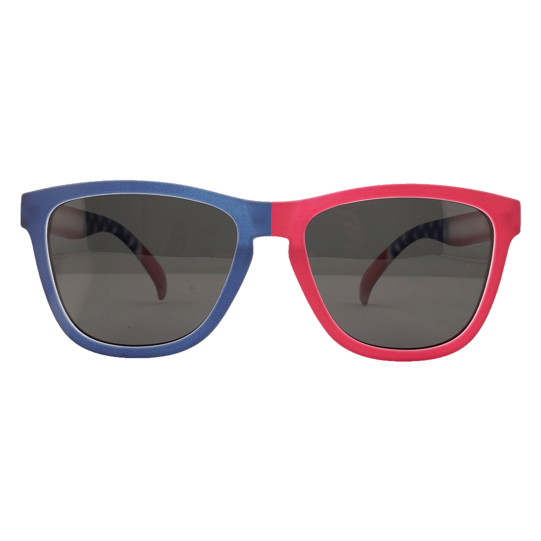 A pair of Wayfarer-style sunglasses with a split blue and red frame and dark lenses, shown against a white background.